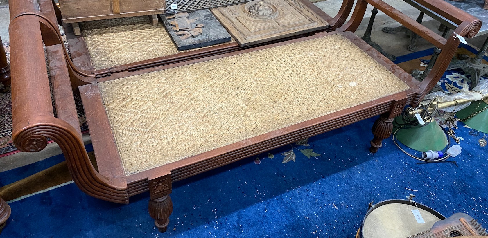 An Asian hardwood day bed with caned seat, width 212cm depth 71cm